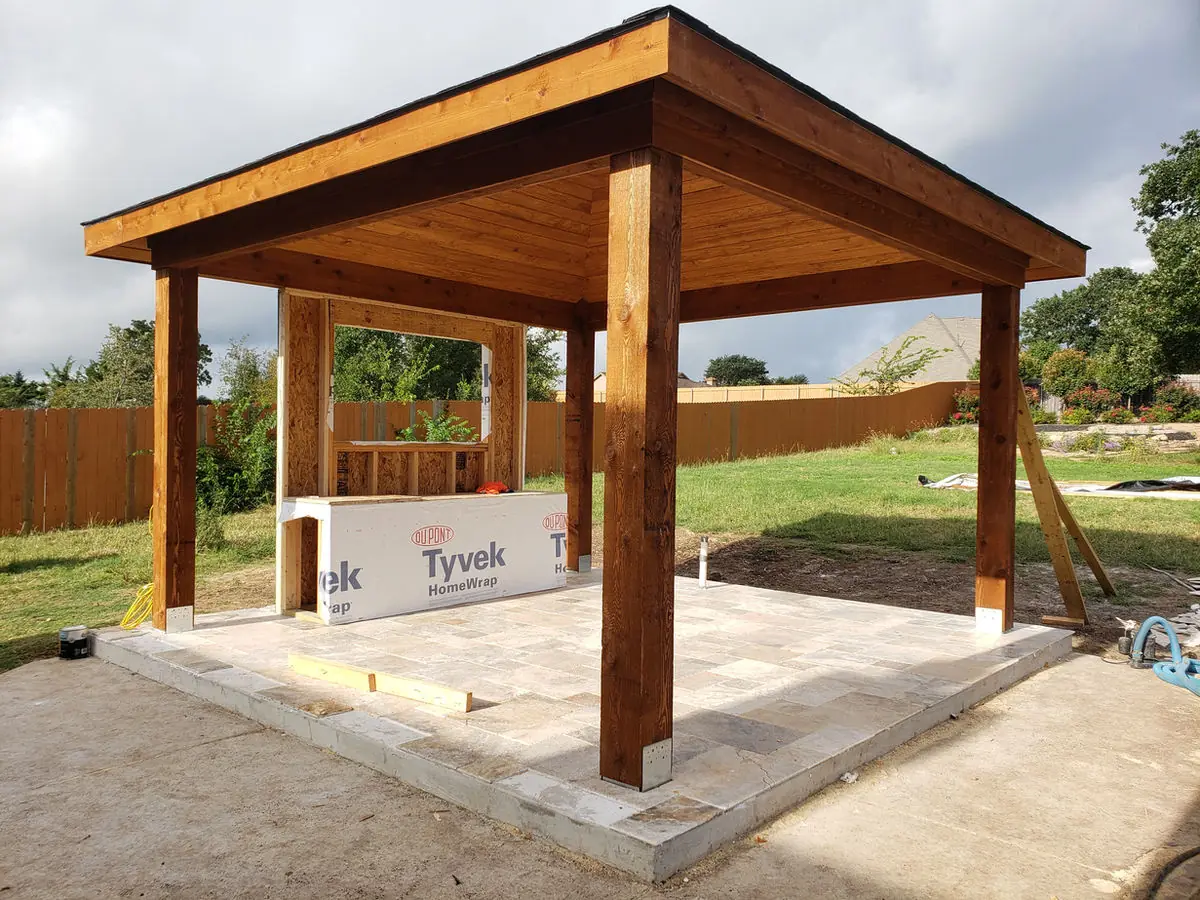 Cedar pavilion under construction on a travertine pad