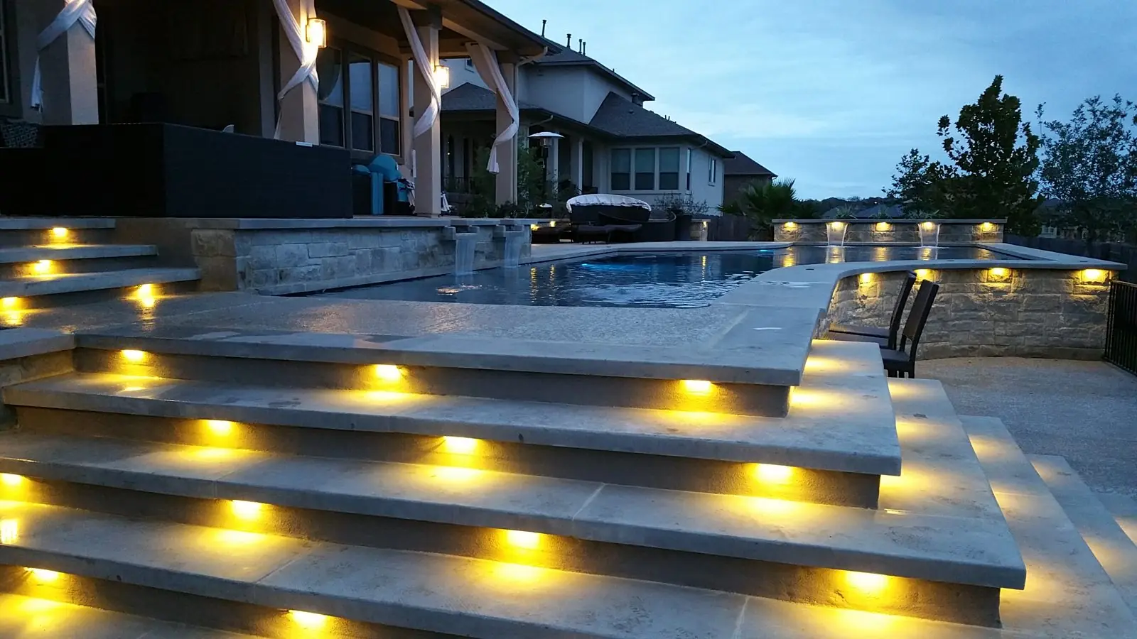 Lit pool steps at dusk