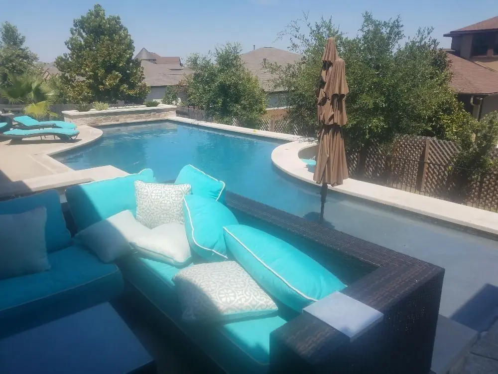 Lounge seating beside a geometric pool